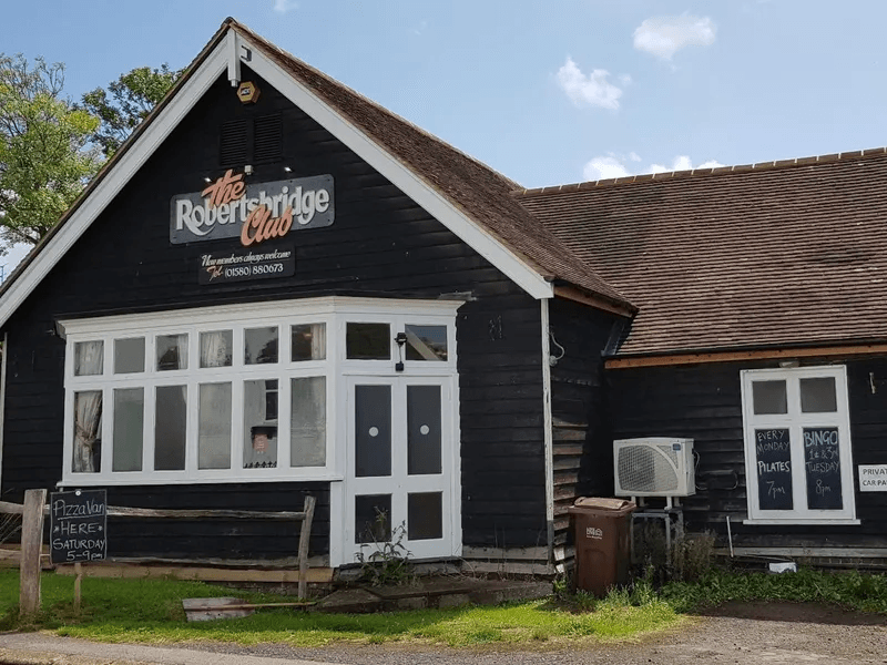 The Robertsbridge Club clubhouse on Station Road: a black weatherboarded building with white window frames and the club's sign above the entrance